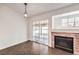 Dining area with herringbone floors and brick fireplace at 320 Mindoro Ave, North Las Vegas, NV 89031