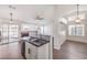 Modern kitchen features herringbone floors, granite island, and stainless steel appliances at 320 Mindoro Ave, North Las Vegas, NV 89031