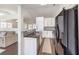 Bright kitchen with white cabinets, granite countertops, and stainless steel appliances at 320 Mindoro Ave, North Las Vegas, NV 89031