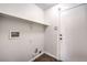 Bright laundry room with built-in shelving and neutral colors at 320 Mindoro Ave, North Las Vegas, NV 89031