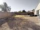 Backyard with gravel, a play structure, and some overgrown weeds at 3807 Aspen Creek Ave, North Las Vegas, NV 89031