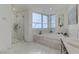 Bright bathroom with a glass shower, soaking tub, and dual sinks at 4471 Dean Martin Dr # 2000, Las Vegas, NV 89103