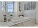 Elegant bathroom features a soaking tub with a marble surround and modern faucet at 4471 Dean Martin Dr # 2000, Las Vegas, NV 89103