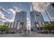 Striking view of the Panorama Towers featuring sleek modern design, retail shops, and lush landscaping at 4565 Dean Martin Dr # 102, Las Vegas, NV 89103