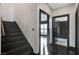 Hallway with dark wood floors, staircase, and access to other rooms, offering a blend of style and functionality at 4565 Dean Martin Dr # 102, Las Vegas, NV 89103