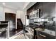 Modern kitchen featuring stainless steel appliances and dark cabinetry, leading to staircase at 4565 Dean Martin Dr # 102, Las Vegas, NV 89103