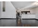 Open-concept living room features dark floors, white walls, and views of the kitchen at 4565 Dean Martin Dr # 102, Las Vegas, NV 89103