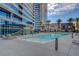 Modern pool and sunbathing deck overlooking the city with mature palm trees at 4565 Dean Martin Dr # 102, Las Vegas, NV 89103