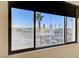 Window view showing a bright cityscape with a palm tree in the foreground at 4565 Dean Martin Dr # 102, Las Vegas, NV 89103