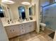 Bathroom boasts dual sinks, a shower, and updated cabinetry at 4604 Possum Berry Ln, North Las Vegas, NV 89081