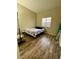 Cozy bedroom with a double bed and wood-look flooring at 4604 Possum Berry Ln, North Las Vegas, NV 89081