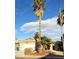 Front view of a house with a tall palm tree and a landscaped yard at 4604 Possum Berry Ln, North Las Vegas, NV 89081