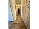 Bright hallway with wood-look flooring and built-in cabinets at 4604 Possum Berry Ln, North Las Vegas, NV 89081