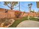 Backyard featuring a brick wall, beautiful garden with mature trees, and a stone patio at 4731 Norwegian St, Las Vegas, NV 89147