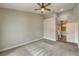 Large bedroom featuring a ceiling fan, carpet flooring, and a glimpse of an ensuite bathroom at 4731 Norwegian St, Las Vegas, NV 89147