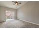 Neutral bedroom with carpet, ceiling fan, and sliding glass door to the backyard at 4731 Norwegian St, Las Vegas, NV 89147