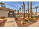 Gated community pool featuring a covered area, mature palm trees and well maintained landscaping at 4731 Norwegian St, Las Vegas, NV 89147