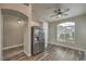 View of the dining area with stainless steel refrigerator, arched entryway, and wood floors at 4731 Norwegian St, Las Vegas, NV 89147