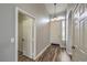 Bright entryway with wood-look floors, a pendant light, and white doors at 4731 Norwegian St, Las Vegas, NV 89147