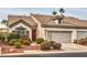 Inviting single-story home featuring a red front door, desert landscaping, and a two-car garage at 4731 Norwegian St, Las Vegas, NV 89147