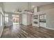 Open living room featuring a fireplace, built-in cabinets, wood-look floors, and a sliding glass door at 4731 Norwegian St, Las Vegas, NV 89147