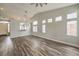 Bright living room with wood-look floors, vaulted ceilings, and an arched room divider at 4731 Norwegian St, Las Vegas, NV 89147