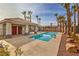 Community pool surrounded by mature palm trees, offering a resort-like experience at 4731 Norwegian St, Las Vegas, NV 89147