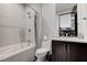 Clean bathroom with shower, toilet, and dark vanity at 5 Highland Cove Ln, Henderson, NV 89011