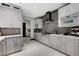 Modern kitchen featuring gray cabinetry and stone backsplash at 5 Highland Cove Ln, Henderson, NV 89011