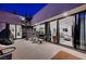 Night view of patio with spiral staircase, seating, and city views at 5 Highland Cove Ln, Henderson, NV 89011