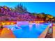 Expansive pool and spa with waterfall feature at night at 5 Highland Cove Ln, Henderson, NV 89011