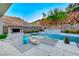 Luxury pool with a waterfall feature and spacious patio area at 5 Highland Cove Ln, Henderson, NV 89011