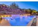 Luxury pool and spa with waterfall feature at night at 5 Highland Cove Ln, Henderson, NV 89011