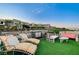 Modern rooftop deck with lounge chairs and outdoor kitchen at 5 Highland Cove Ln, Henderson, NV 89011