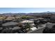 Aerial view of a two-story house with a three-car garage and palm trees in a residential neighborhood at 528 Copper View St, Henderson, NV 89052