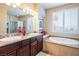 Bathroom with granite double vanity, large soaking tub and shower at 528 Copper View St, Henderson, NV 89052