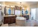 Double vanity bathroom with a large oval soaking tub at 528 Copper View St, Henderson, NV 89052