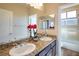 Double vanity bathroom with granite countertop, large mirror, and separate shower at 528 Copper View St, Henderson, NV 89052