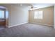 Bright bedroom with carpet, ceiling fan and window with shutters at 528 Copper View St, Henderson, NV 89052