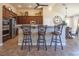 Kitchen boasts a breakfast bar with seating and dark wood cabinets at 528 Copper View St, Henderson, NV 89052