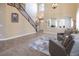 Living room with high ceilings, tiled floors, and seating area at 528 Copper View St, Henderson, NV 89052