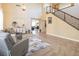 Living room with high ceilings, tiled floors, and seating area at 528 Copper View St, Henderson, NV 89052