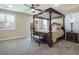 Luxurious main bedroom with a canopy bed and plush carpeting at 528 Copper View St, Henderson, NV 89052