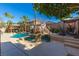 Inviting pool with a rock waterfall feature, pergola, and patio furniture at 528 Copper View St, Henderson, NV 89052