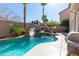 Luxury pool with rock waterfall, slide, and built-in spa at 528 Copper View St, Henderson, NV 89052