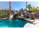 Stunning pool with a rock waterfall, slide, and spacious patio at 528 Copper View St, Henderson, NV 89052