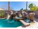 Refreshing pool with a large rock water feature and a slide at 528 Copper View St, Henderson, NV 89052