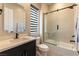 Well-lit bathroom featuring a shower-over-tub combo with glass doors and modern fixtures at 5436 Succulent Rose Dr, Las Vegas, NV 89135