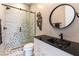 Modern bathroom featuring stylish tiles, a glass-enclosed shower, and a sleek black countertop and sink at 5436 Succulent Rose Dr, Las Vegas, NV 89135