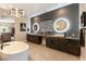 Beautiful bathroom featuring dual vanities, a soaking tub, and modern lighting at 5436 Succulent Rose Dr, Las Vegas, NV 89135